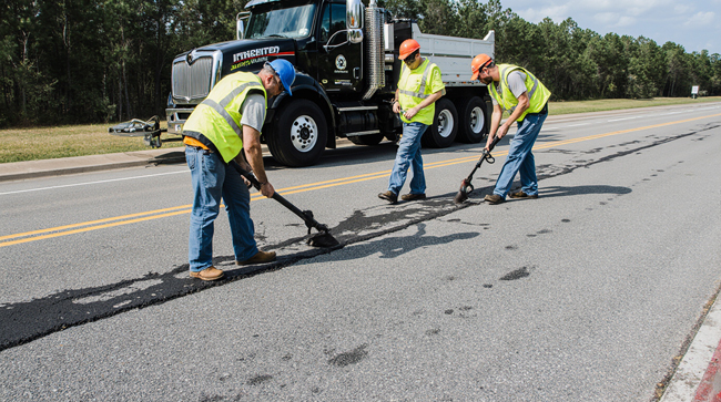 Pavel Pavement Crew Sealing Asphalt Cracks